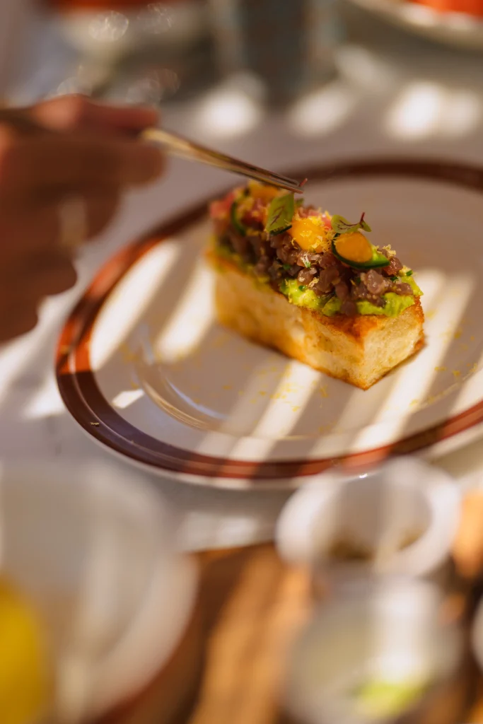 Tartare di tonno su focaccia calda con guacamole guarnita dallo chef a Nikki Beach Costa Smeralda